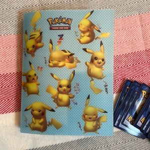 Pokémon Cards and holding book